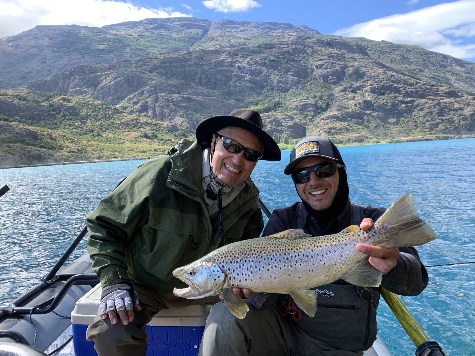 Guest and guide with a brown trout on the boat at Patagonia Baker Lodge