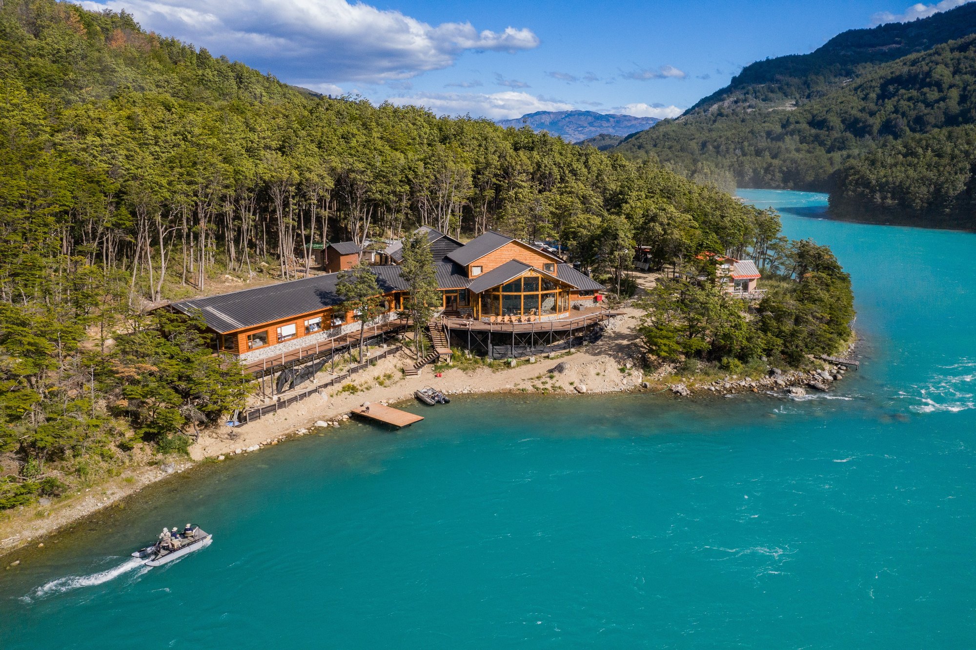 Aerial view of Patagonia Baker Lodge on turquoise water near Coyhaique, Chile