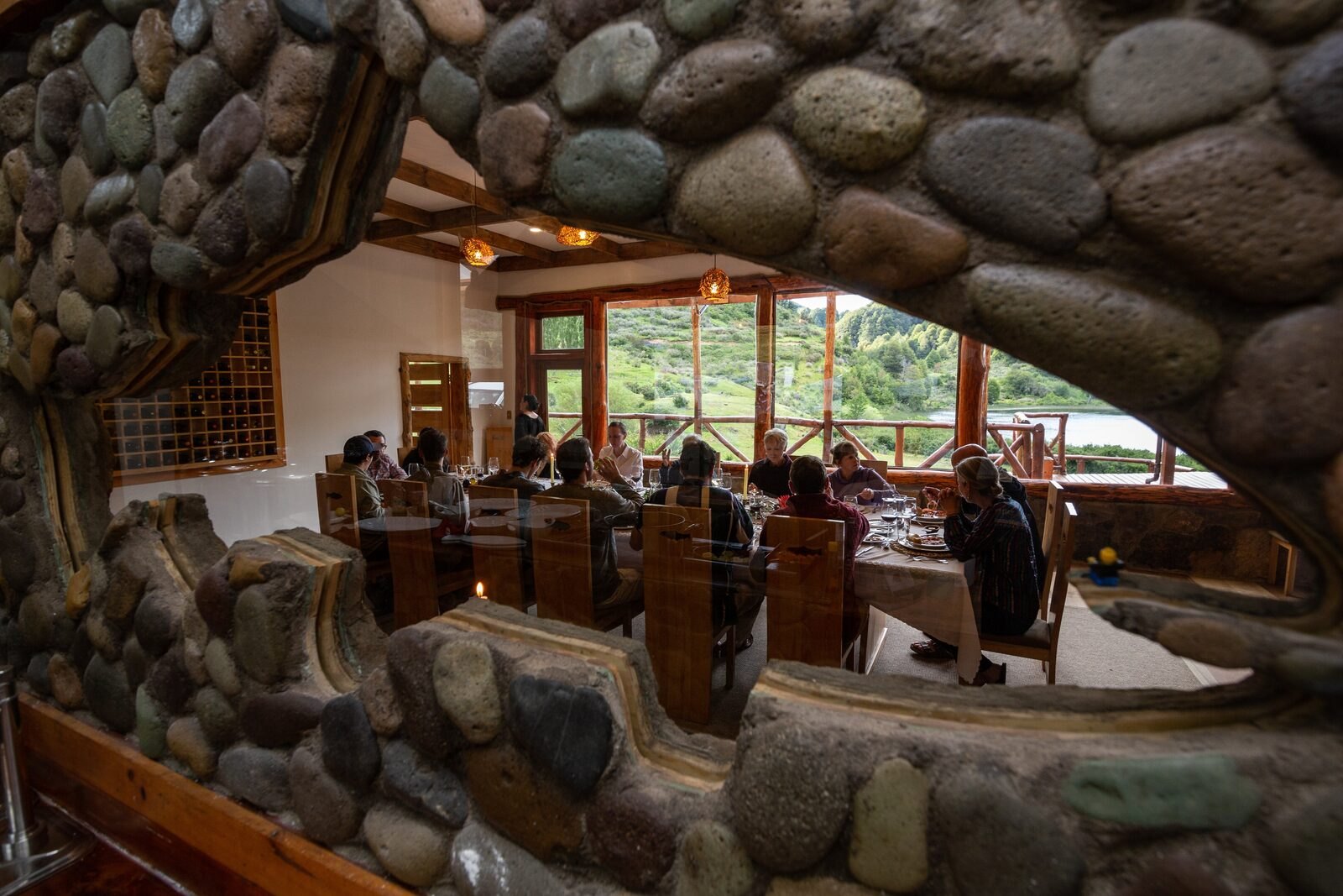 Dining room at Magic Waters Lodge seen through a stone arch with lake view
