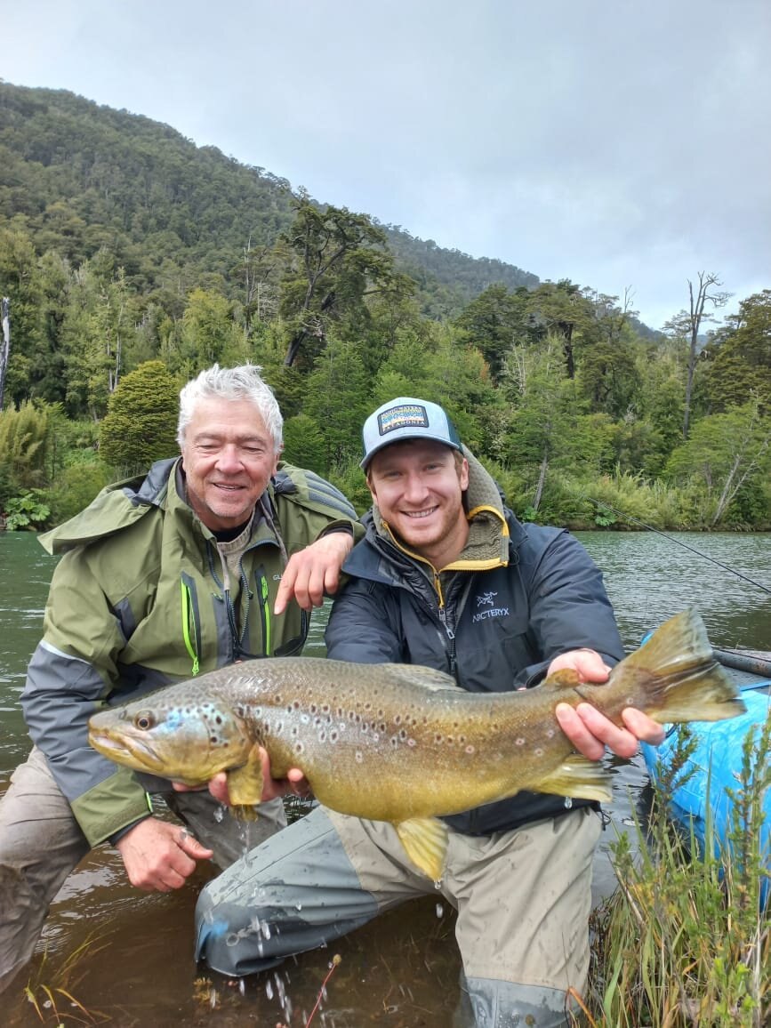 Guest and companion with a wild brown trout at River of Dreams Basecamp