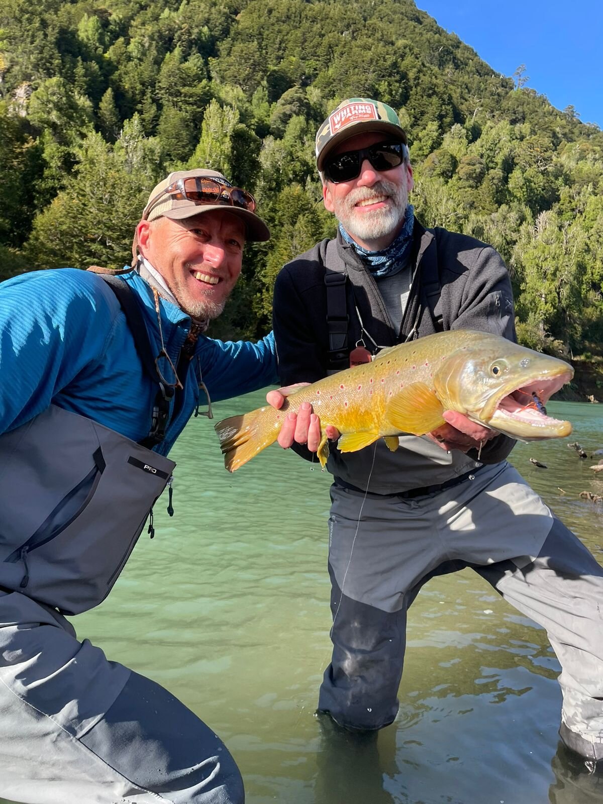 Head guide and guest with a brown trout on the river at River of Dreams