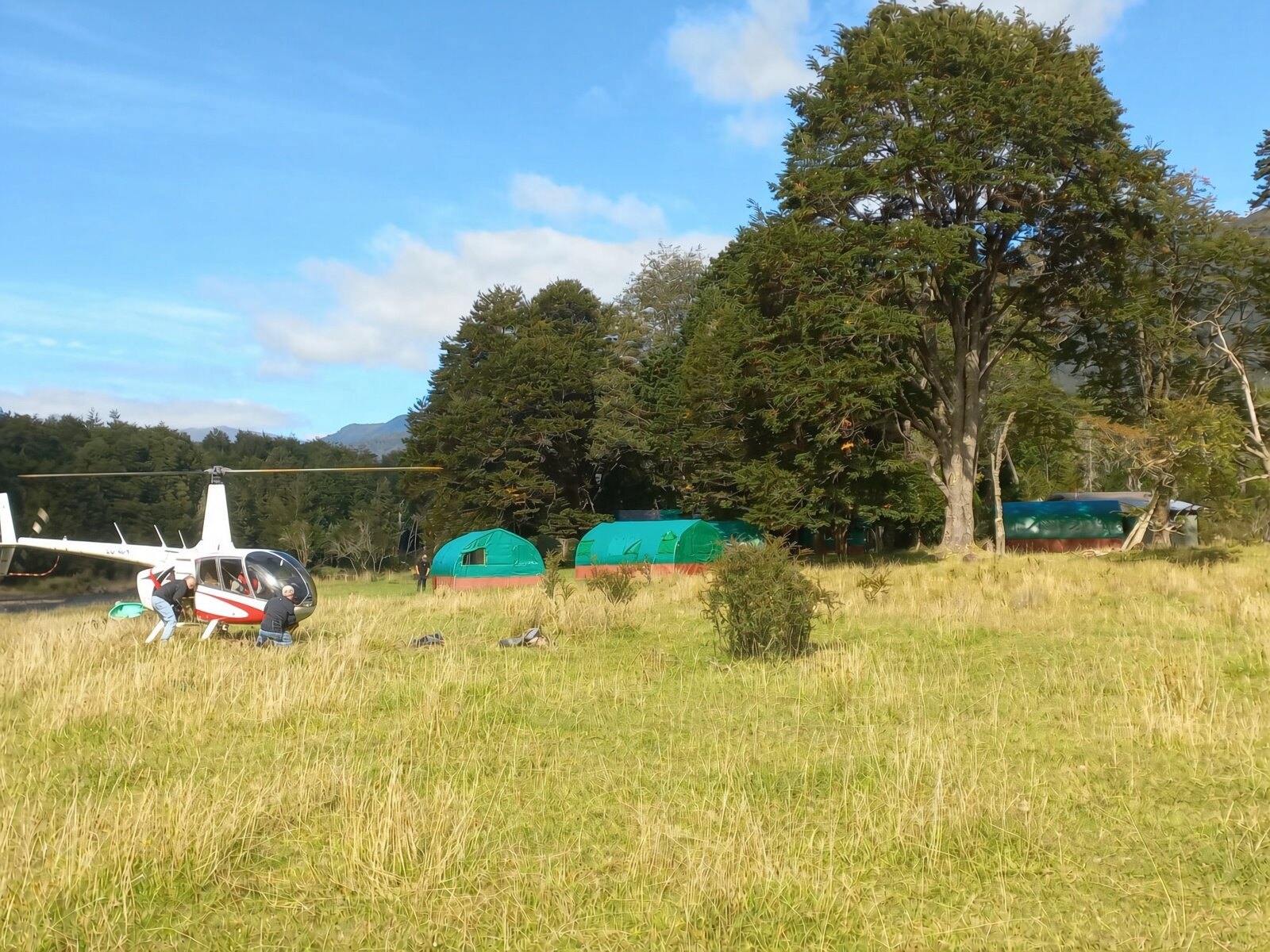 Helicopter landing at River of Dreams Basecamp in the Río Blanco valley